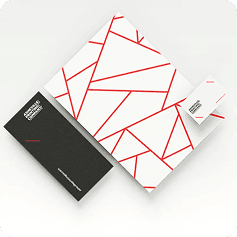 Stationery laid out on a wooden desk